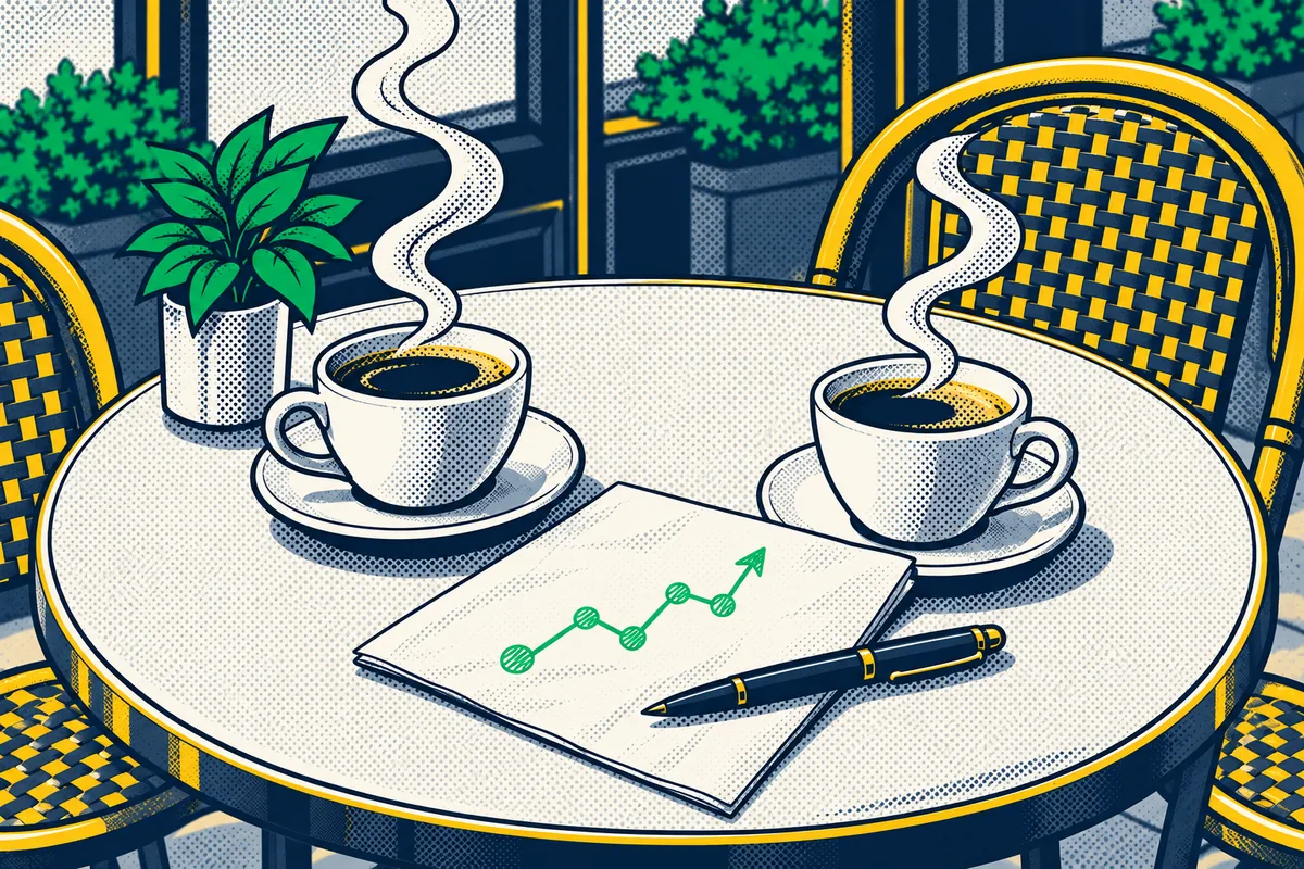 Café table with two cups of coffee and a sketch on a napkin